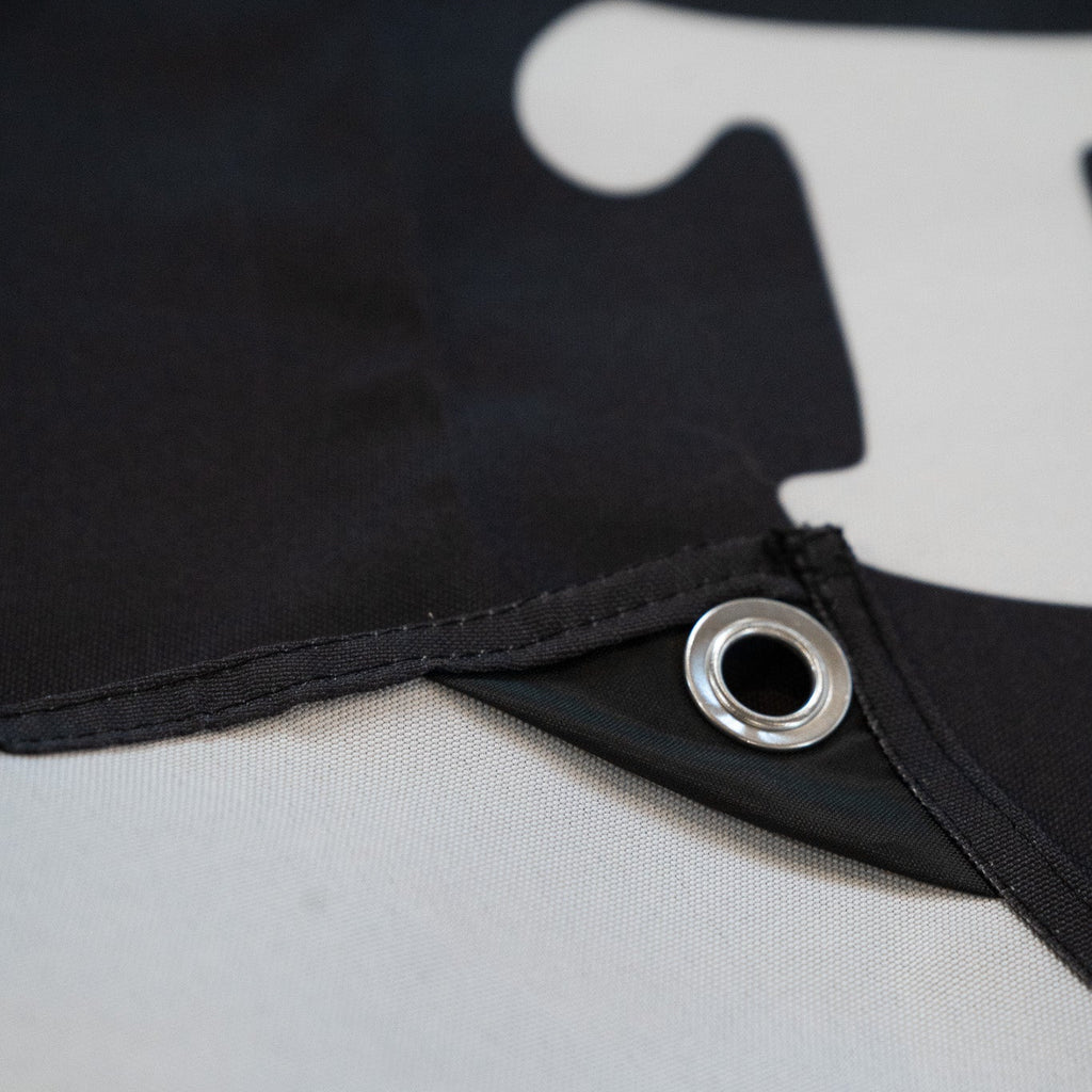 Close up of corner and metal eyelet of a Black banner 