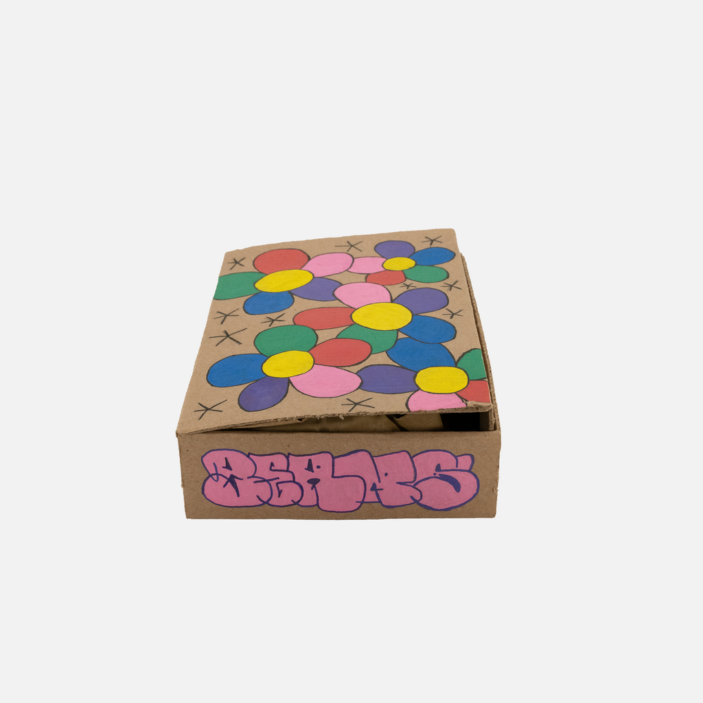 Cardboard box with colorful flower patterns and 'BEANS' branding on a white background